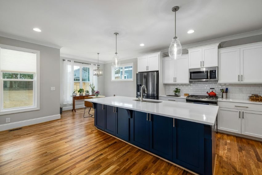 wooden floor kitchen with white cabinets