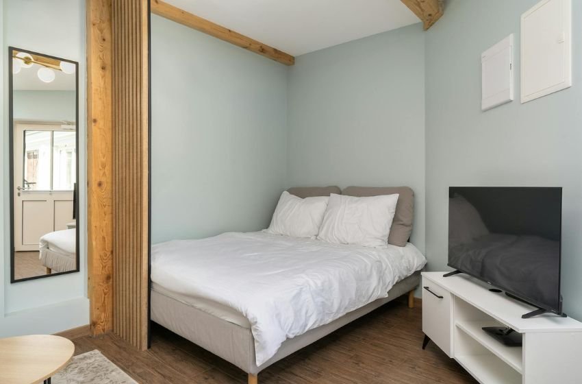 small bedroom with corner bed