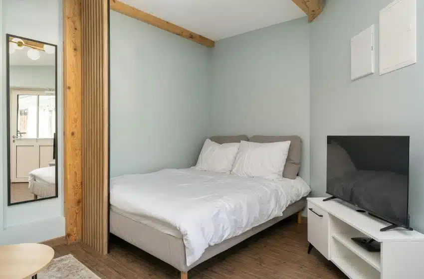 small bedroom with corner bed