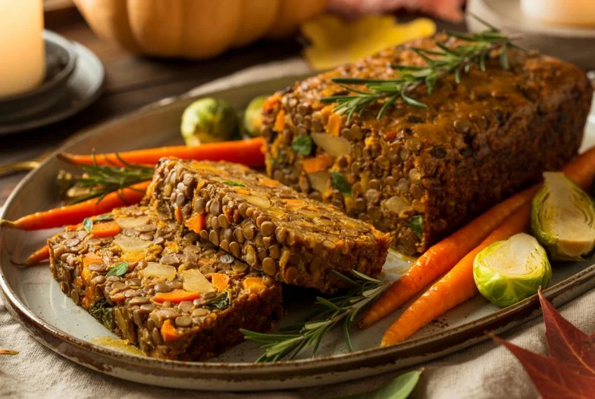 Sliced vegetarian lentil loaf on a platter.