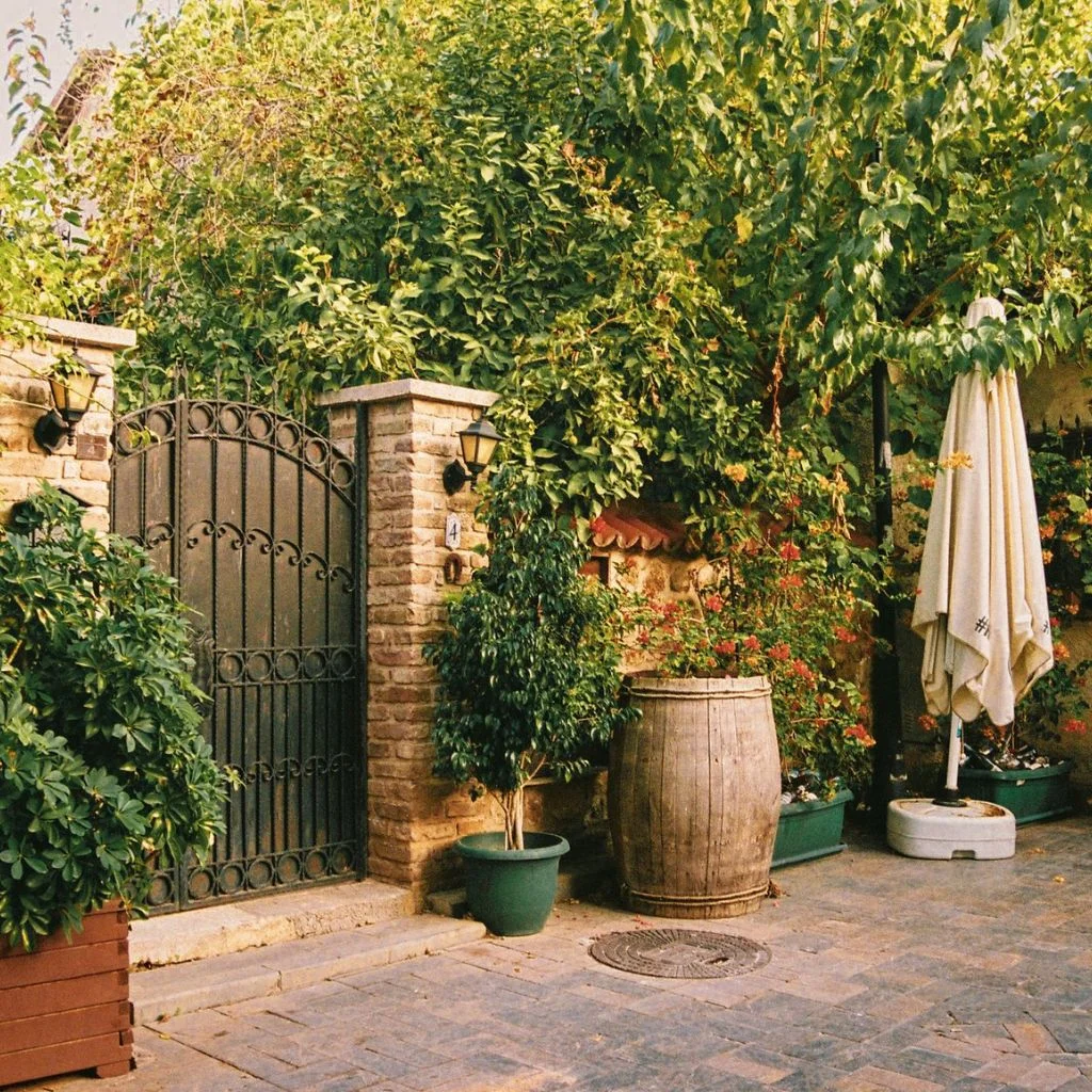 Californian Bungalow Pairs Raw Brick With Black Steel Gates