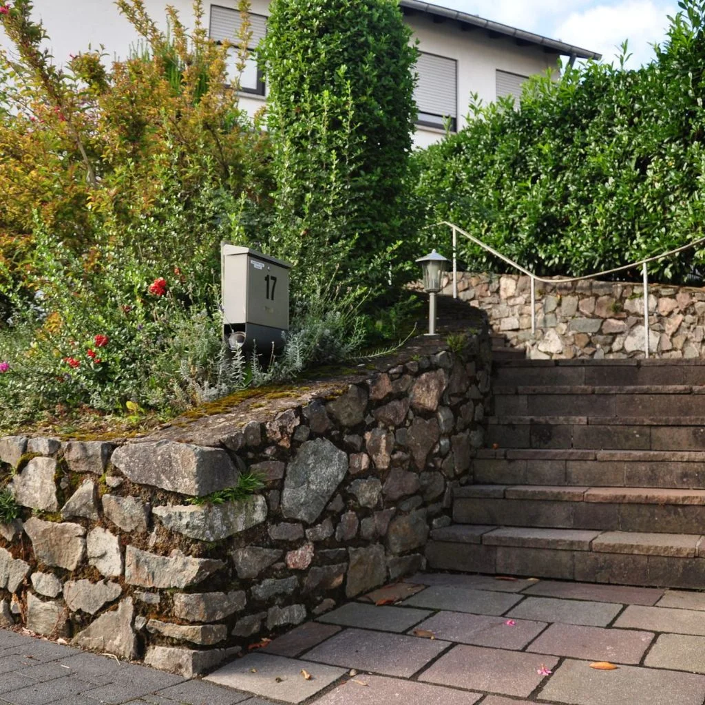 Curved Brick Fences Bring Movement to a Straight Property Line