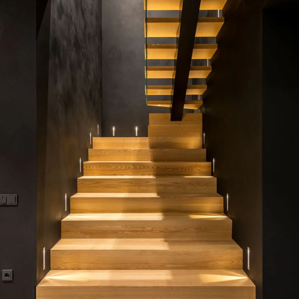 Layered Lighting Adds Warmth to a Windowless Stairway