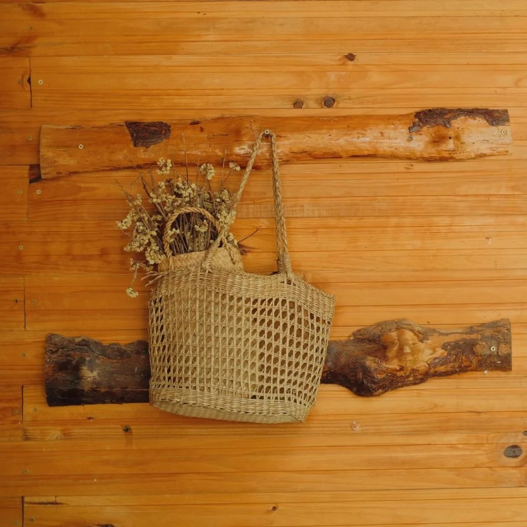 log-style coat rack built from thick offcuts left with natural bark edges brings that feel to an entryway.