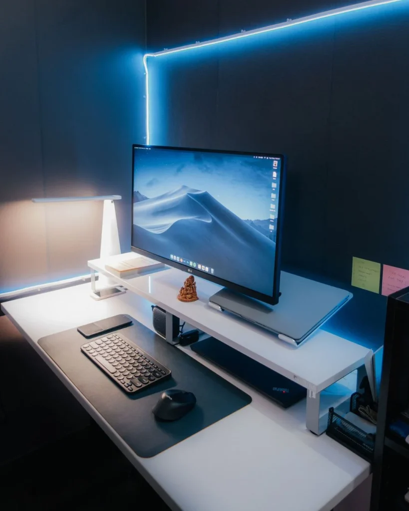 basement home office desk lit by a daylight-mimicking LED bulb, cool white tone