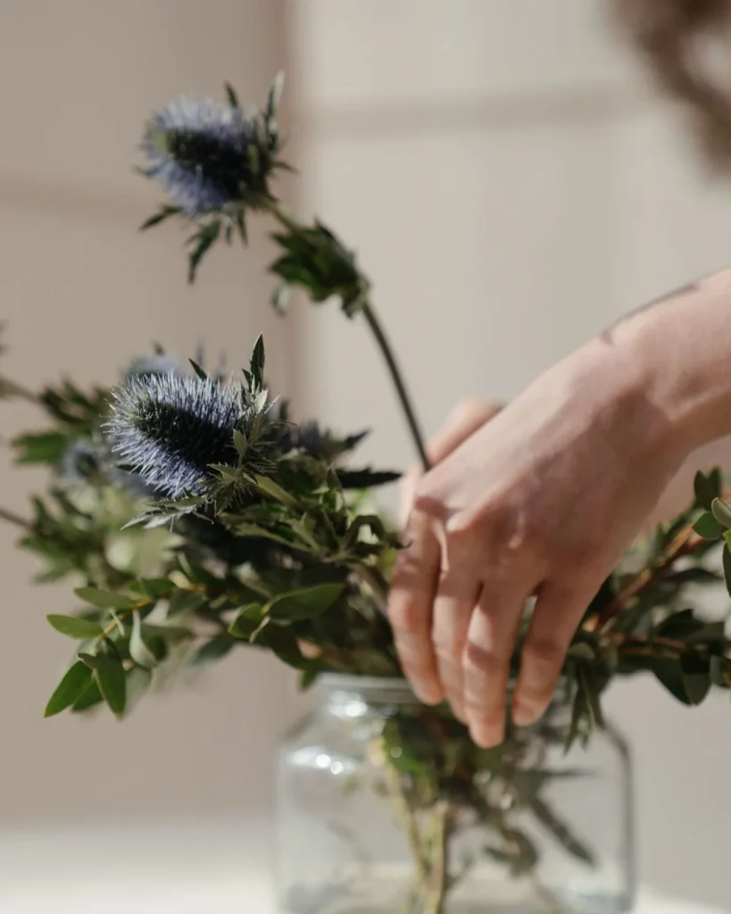hands styling artificial plant branches