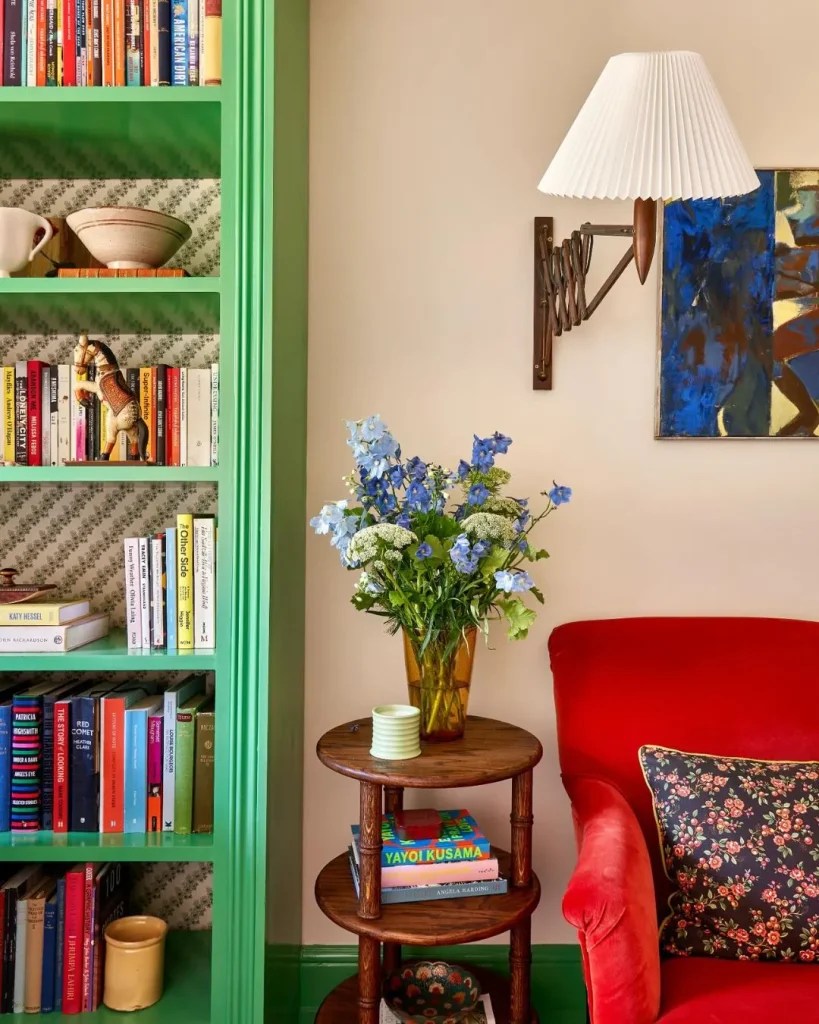 Bookcase with deep green leaf wallpaper