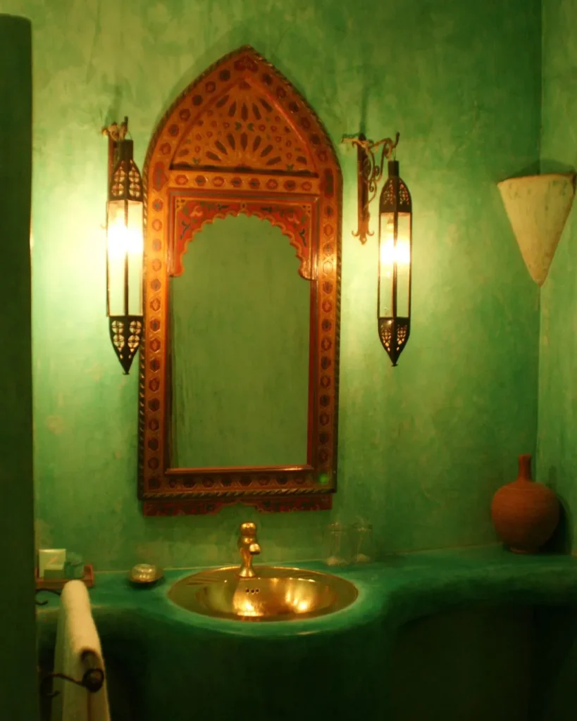Hammered copper mirror above a copper vessel basin