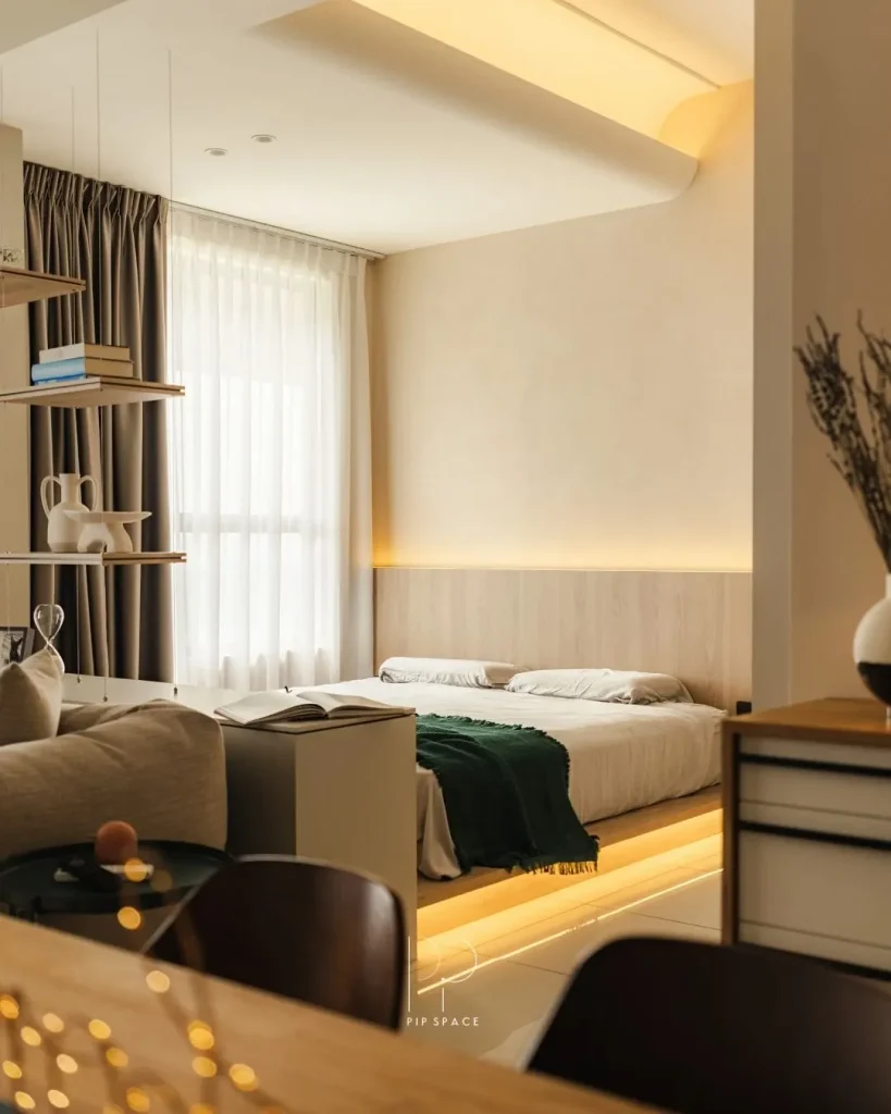 Warm LED glow behind a bedroom headboard casting a soft halo on the wall