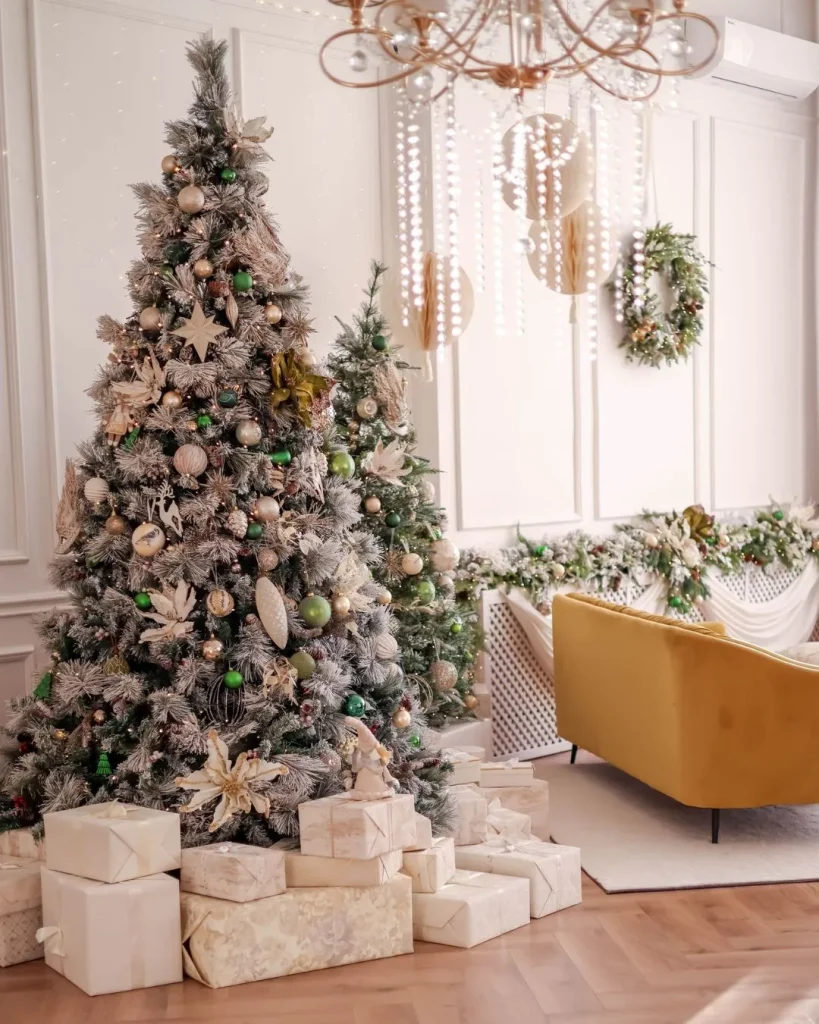 White flocked tree with matte black baubles and gold stars