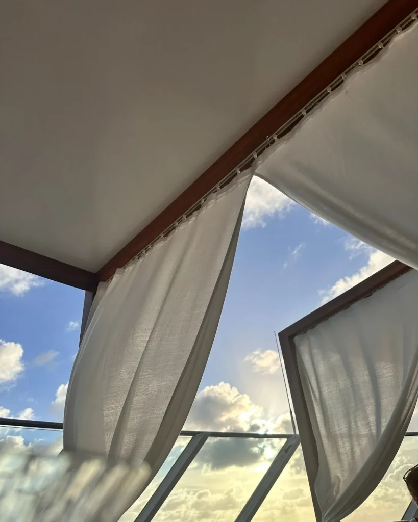 airy sheer white fabric draped ceiling sunlit room
