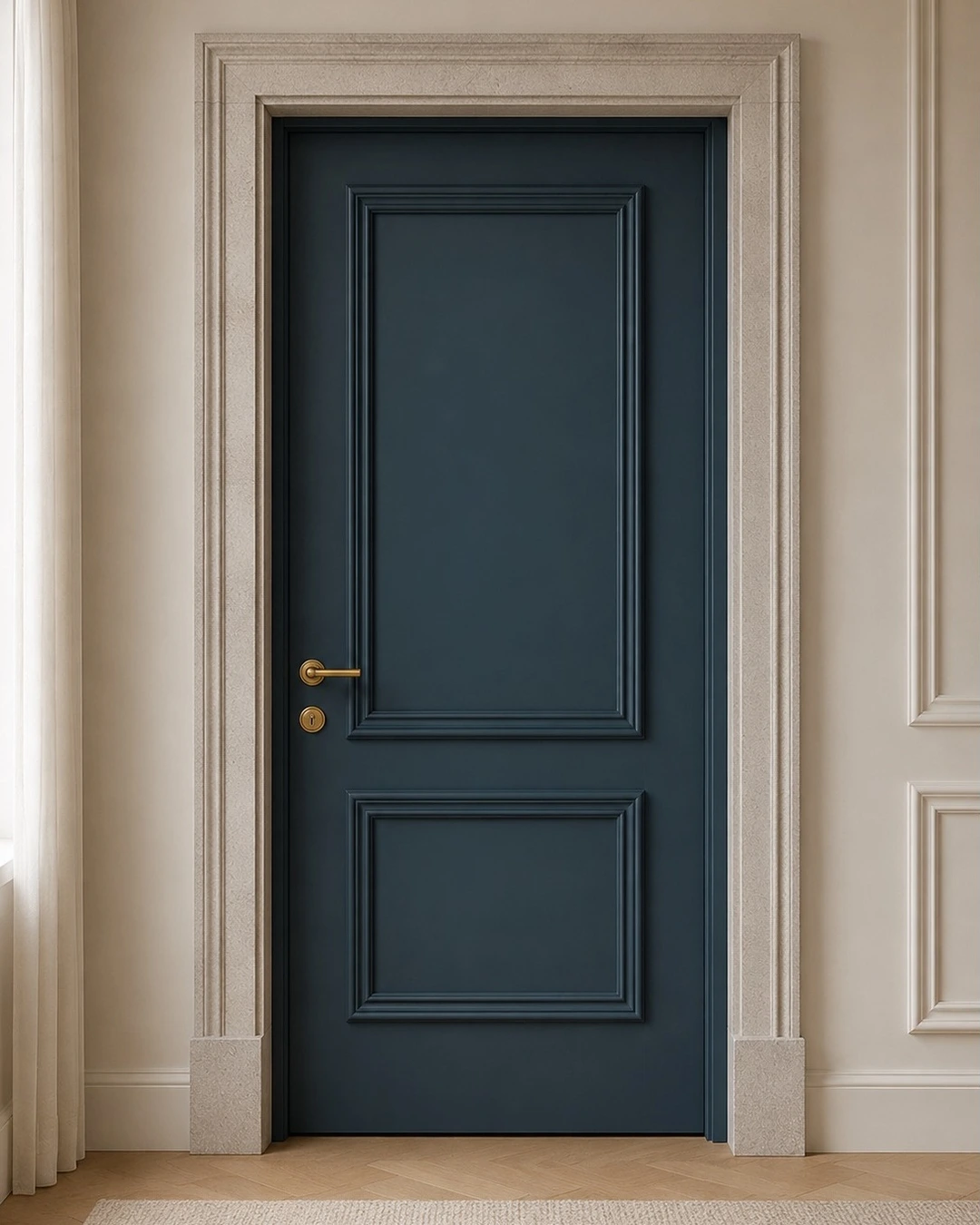 Deep navy paneled door with gold handle and light stone trim surround