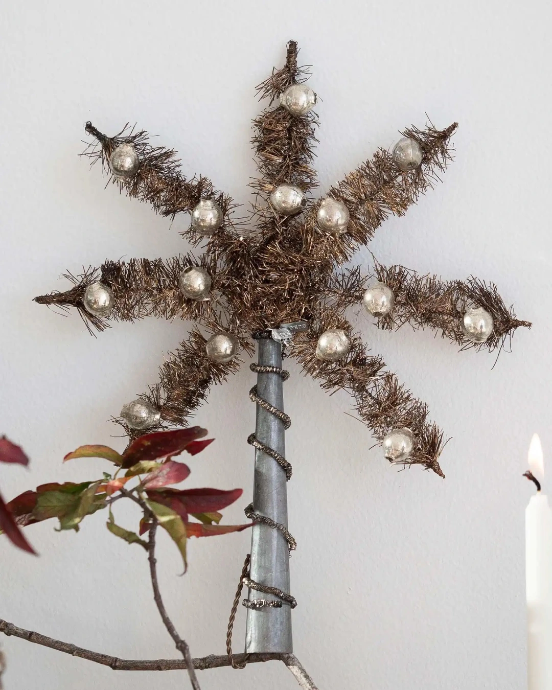 Brown tinsel star tree topper with silver mercury-glass beads on a tall silver cone base