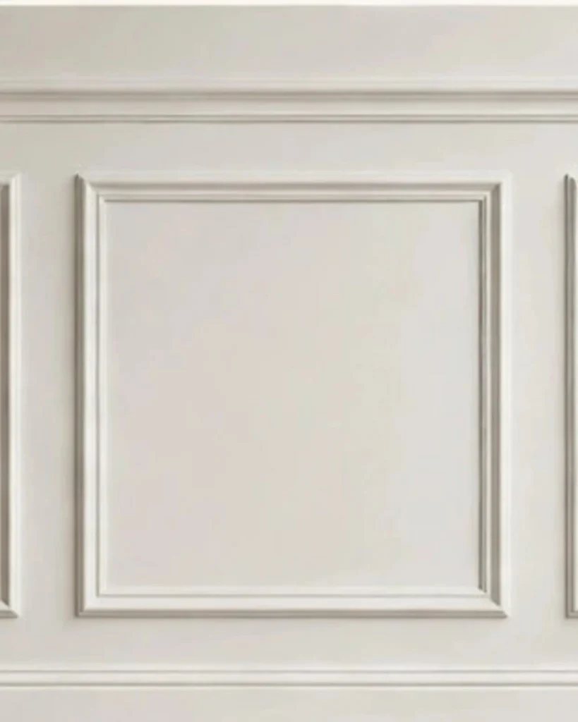 Close-up of cream picture-frame wall molding panels with decorative trim