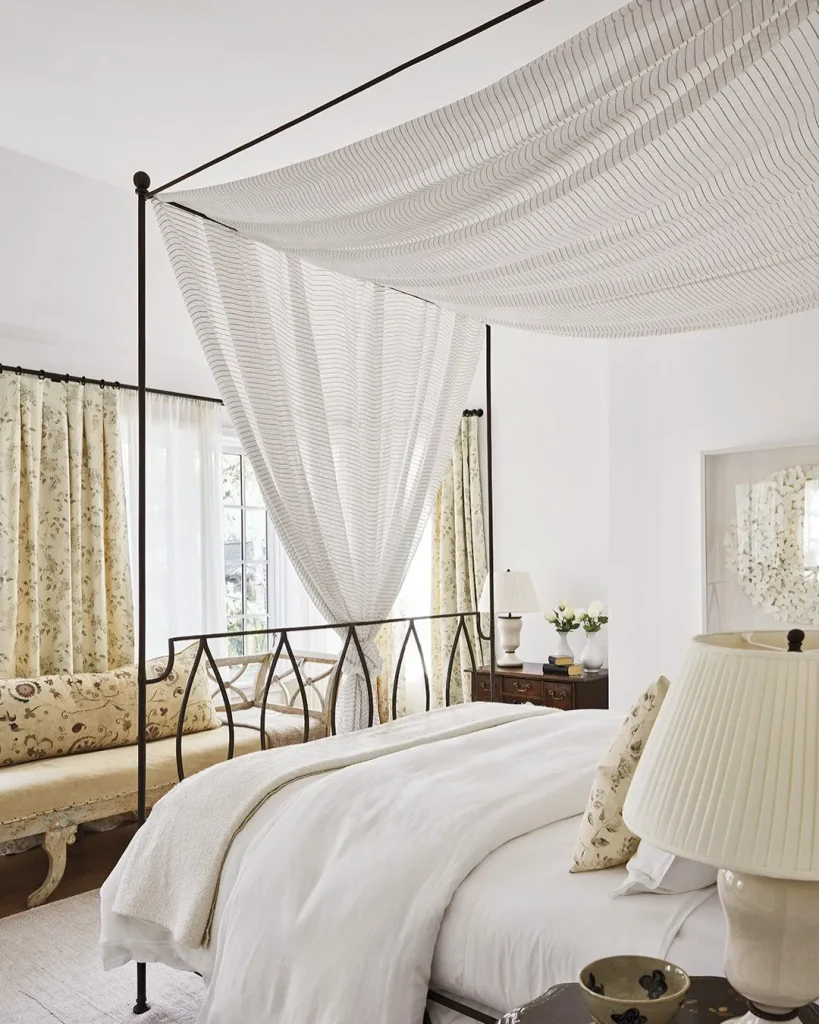 sheer fabric canopy above bed neutral bedroom