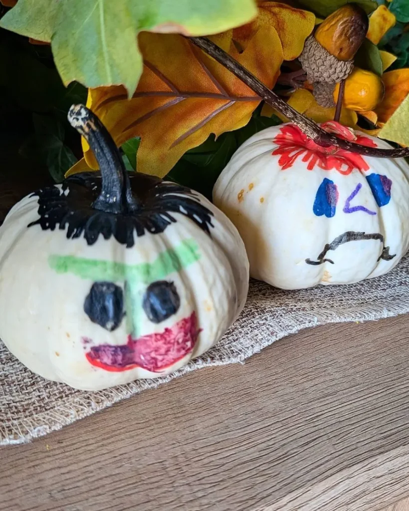 white painted pumpkins on porch steps